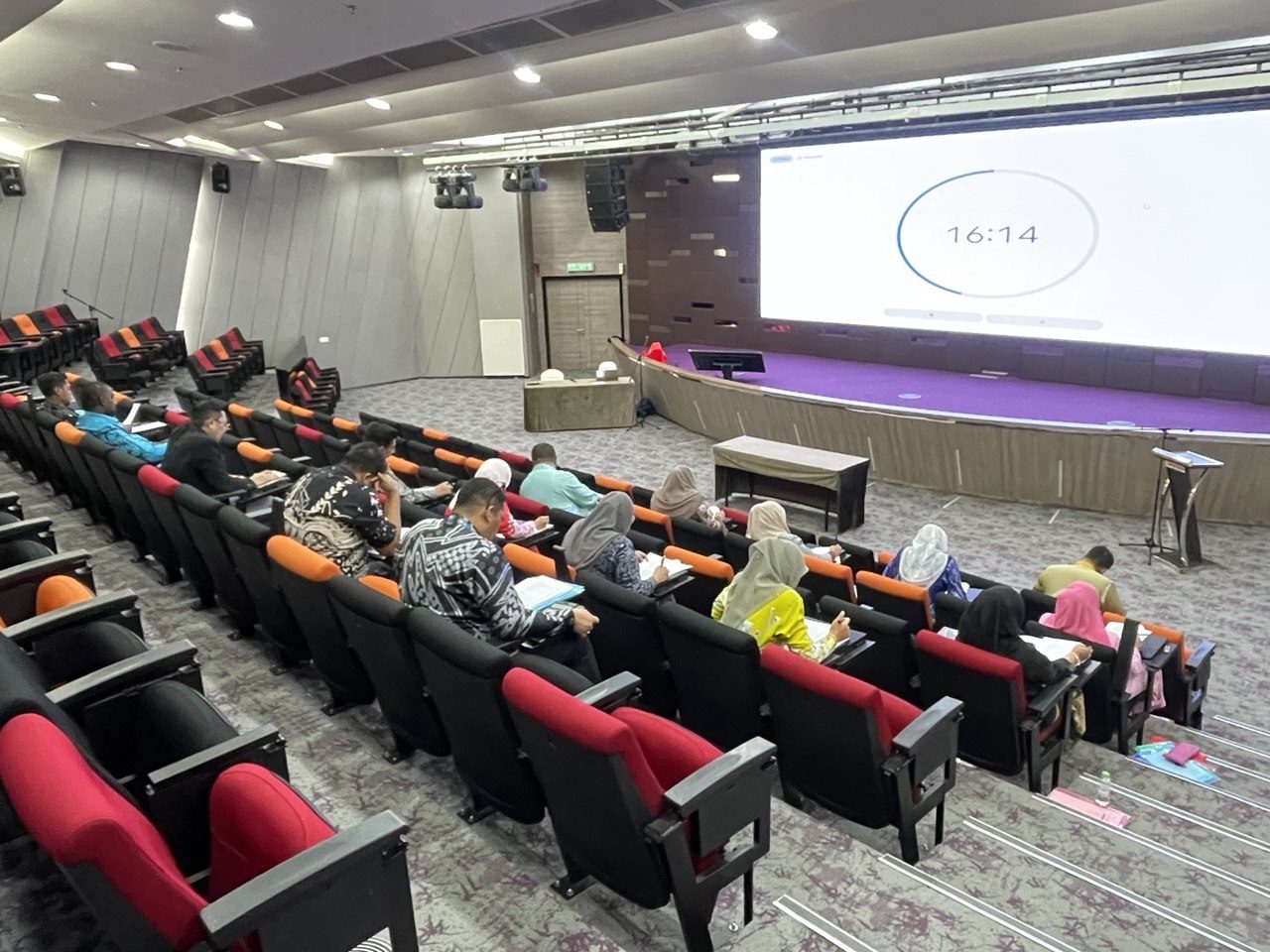 Participants seated in an auditorium during an assessment or learning session
