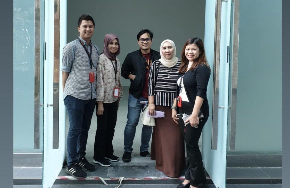 Team members standing together at a client site